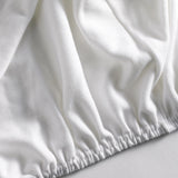 Detailaufnahme des Spannbetttuchs - elastisches, perfekt sitzendes Spannleintuch in Premium-Qualität